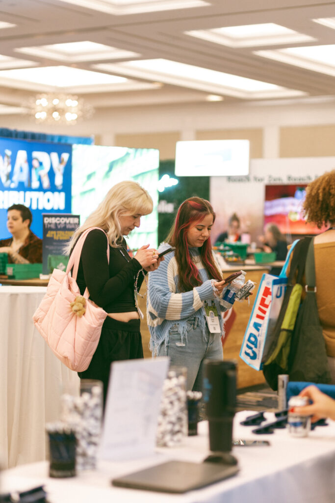 Two RVTs visit a booth at the 2026 OAVT Conference trade show hall.